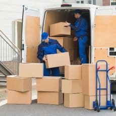 two-men-unpacking-boxes-from-van