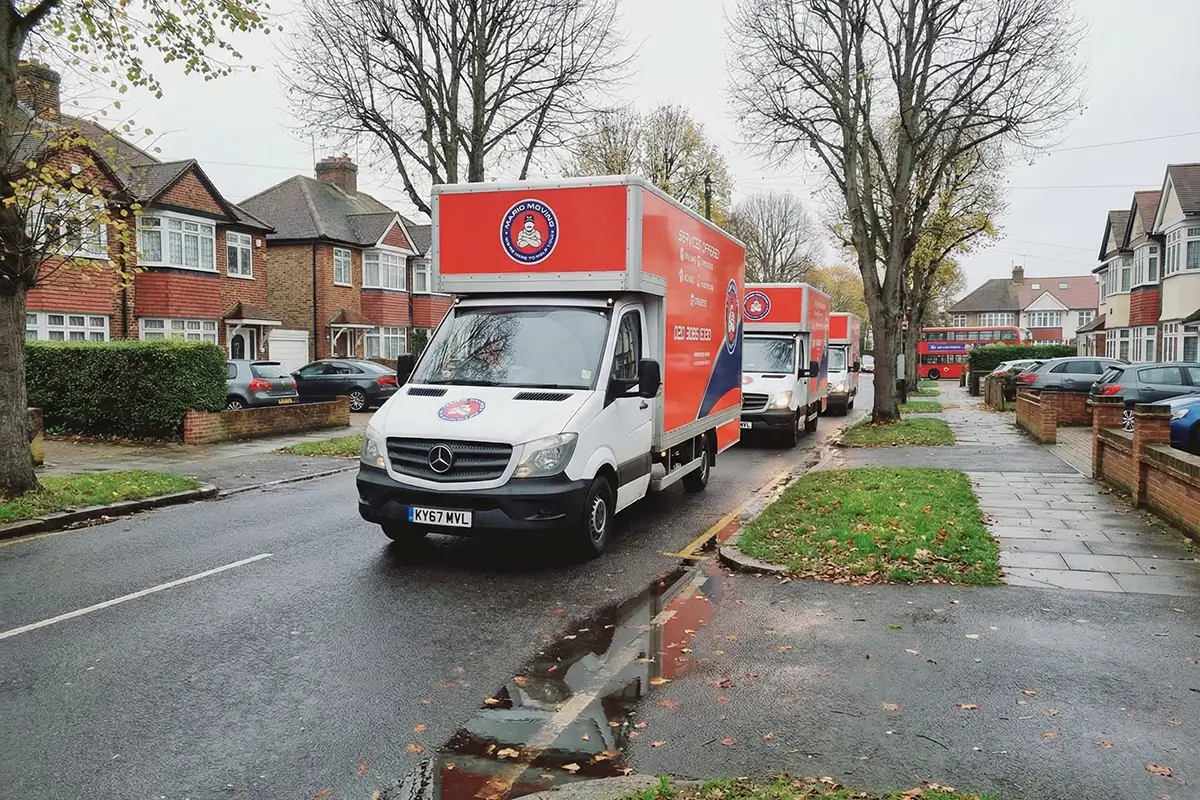 Mario Moving vans parked on a suburban UK street ready for service.